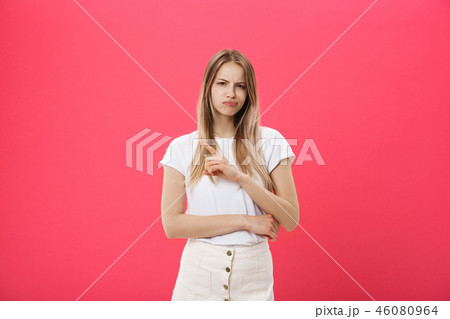 Shot of bored annoyed beautiful teenage girl with straight blond hair looking at camera with boring Shot of bored annoyed beautiful teenage girl with straight blond hair looking at camera with boring 46080964
