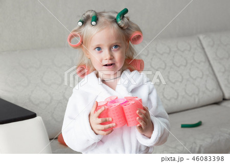 Happy little caucasian girl with hair curlers. Happy little caucasian girl with hair curlers. 46083398