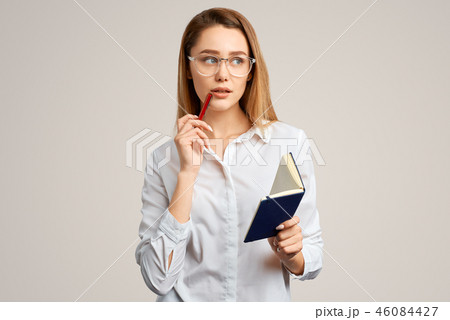 Thoughtful beautiful blonde girl in a white blouse Thoughtful beautiful blonde girl in a white blouse 46084427