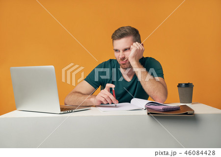 Tired young male works overtime Tired young male works overtime 46084428