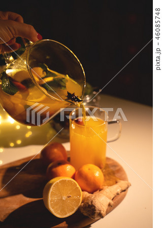 Spicy tea in a cup with cinnamon, honey, turmeric on a wooden background. Hot drink. Copy space Spicy tea in a cup with cinnamon, honey, turmeric on a wooden background. Hot drink. Copy space 46085748