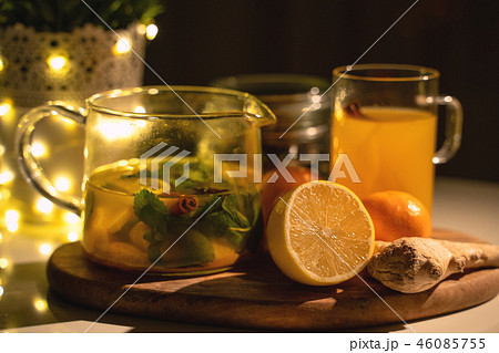 Spicy tea in a cup with cinnamon, honey, turmeric on a wooden background. Hot drink. Copy space Spicy tea in a cup with cinnamon, honey, turmeric on a wooden background. Hot drink. Copy space 46085755