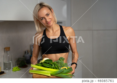 a sporty girl with set of green vegetables a sporty girl with set of green vegetables 46085761