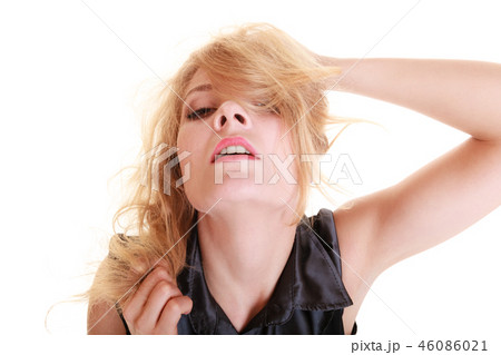 Sexy attractive blonde woman pulling her messy hair 46086021
