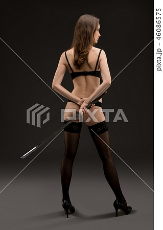 Young woman in underwear and stockings rearview 46086575