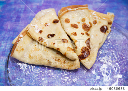 two baked pancakes lie on a transparent plate two baked pancakes lie on a transparent plate 46086688