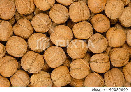 Walnuts background close up, pile of unshelled nut Walnuts background close up, pile of unshelled nut 46086890