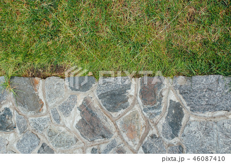 Stone wall and green grass 46087410