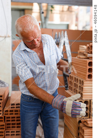 Man working with red brick Man working with red brick 46094148