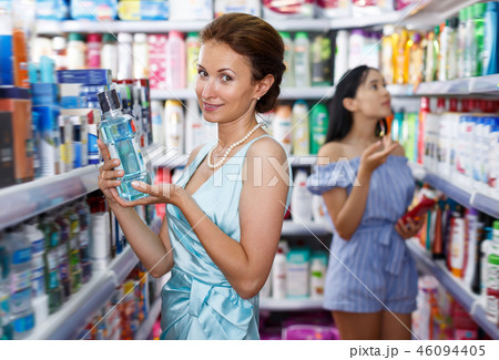 Ordinary woman looking for effective mouthwash Ordinary woman looking for effective mouthwash 46094405