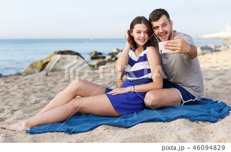 Happy loving couple resting and taking selfie 46094829