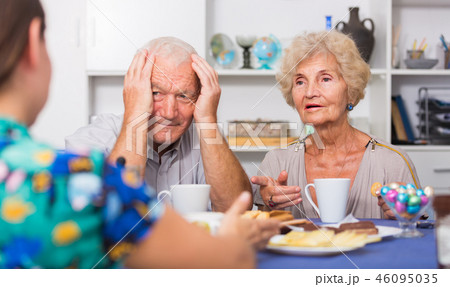 Serious mature parents having unpleasant talk with daughter Serious mature parents having unpleasant talk with daughter 46095035