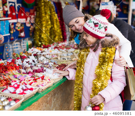 Positive woman with small daughter in market 46095381