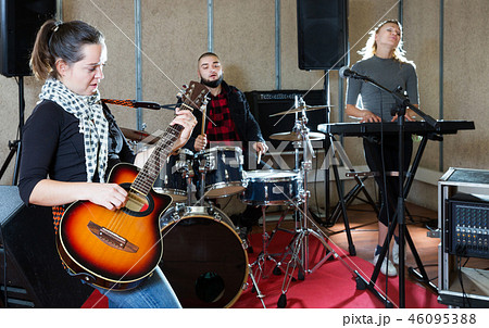 excited girl rock singer with guitar during rehearsal excited girl rock singer with guitar during rehearsal 46095388