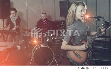 excited girl rock singer with guitar during rehearsal 46095445