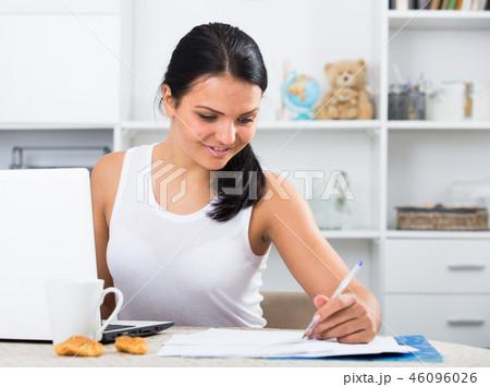 Young woman sitting at laptop 46096026