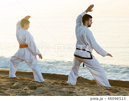 Man and boy practising karate Man and boy practising karate 46096513