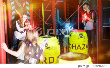 Parents and children playing laser tag in beams 46096862