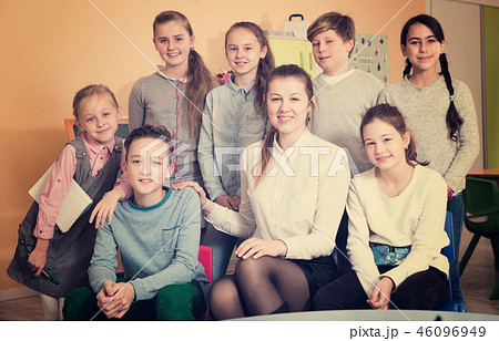 Female teacher with schoolchildren in classroom Female teacher with schoolchildren in classroom 46096949