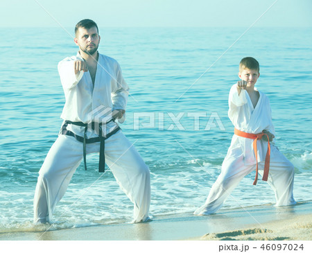 Father and son are practicing karate Father and son are practicing karate 46097024