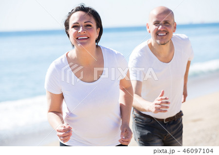 Mature couple jogging together . Mature couple jogging together . 46097104