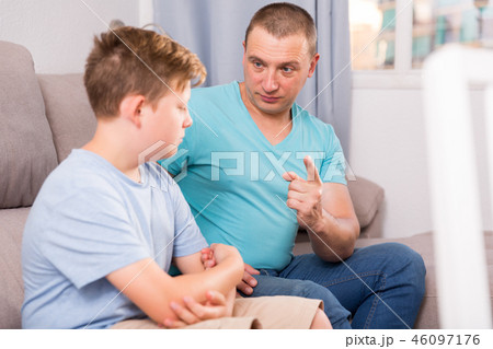 Sad guy with his father are resting and talking about teenage life 46097176