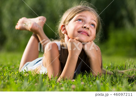girl in lying on grass in park 46097211