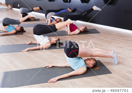 Females practicing yoga in studio 46097701