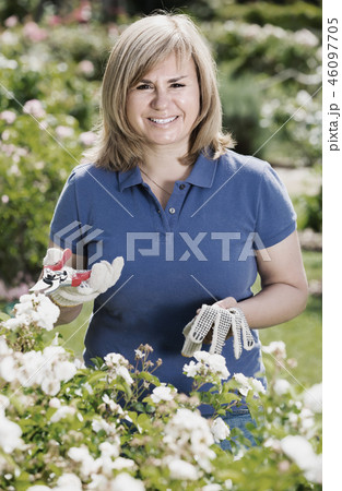 mature woman in garden on summer day. mature woman in garden on summer day. 46097705