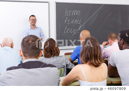 Young lecturer talking to mixed age students Young lecturer talking to mixed age students 46097809