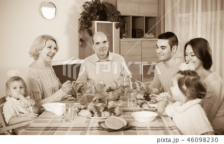 family sitting at table for dinner family sitting at table for dinner 46098230