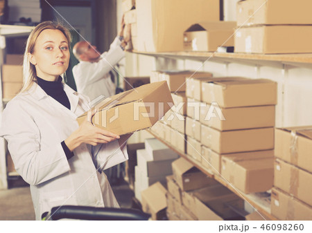 Worker standing with boxes in production workshop Worker standing with boxes in production workshop 46098260