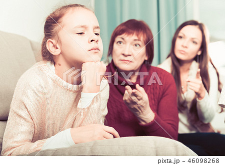 Offended little while mom and granny scolding her 46098268