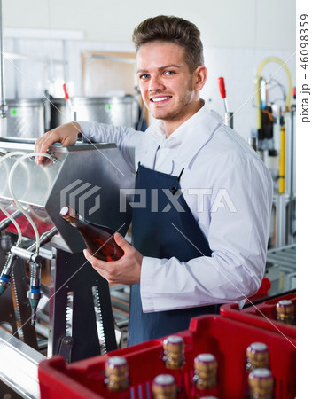 Male worker packaging wine bottles at sparkling wine factory Male worker packaging wine bottles at sparkling wine factory 46098359