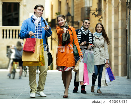 Group of young tourists with purchases Group of young tourists with purchases 46098455