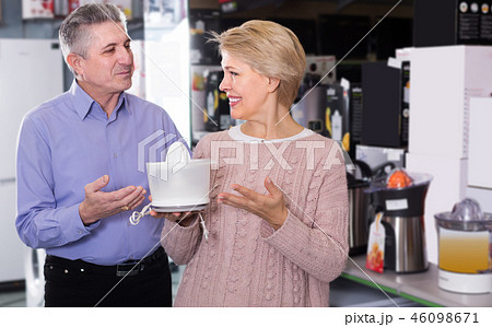 mature married couple in shopping center buys small kitchen household appliances mature married couple in shopping center buys small kitchen household appliances 46098671