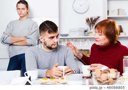 Woman calming upset guy during quarrel with girlfriend Woman calming upset guy during quarrel with girlfriend 46098805