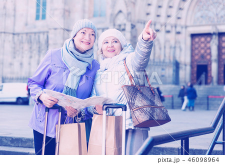 Senior females traveling with city map Senior females traveling with city map 46098964