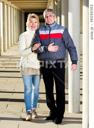 Married couple goes for walk between concrete pillars 46099363