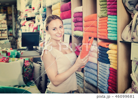 Young woman buying soft towels in textile store Young woman buying soft towels in textile store 46099681