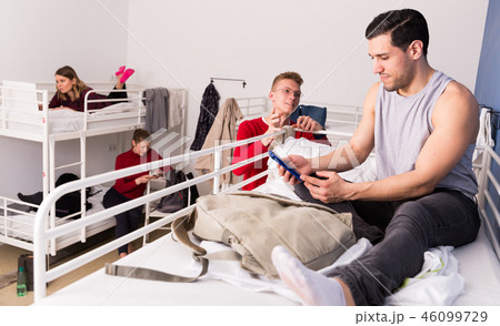Man talking to guy in hostel bedroom Man talking to guy in hostel bedroom 46099729