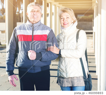 Positive husband and wife are walking together Positive husband and wife are walking together 46099893