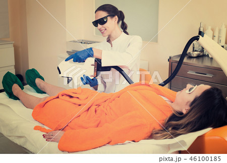 female client doing laser hair removal from legs female client doing laser hair removal from legs 46100185