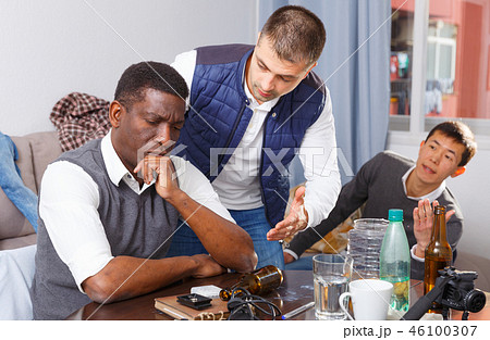 Offended man during quarrel with friends 46100307