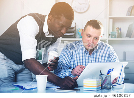Two businessmen working in the office at the laptop 46100817