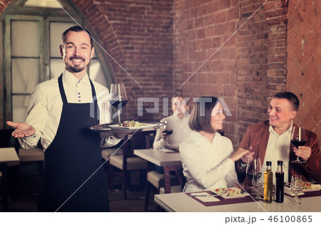 smiling man waiter demonstrating country restaurant 46100865