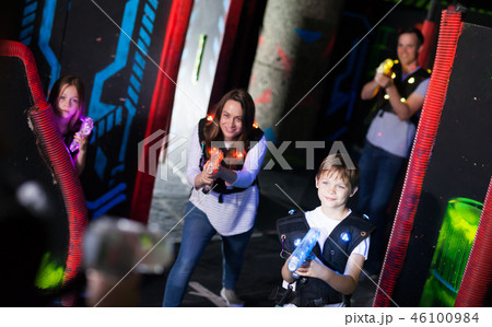 Parents and children playing laser tag 46100984