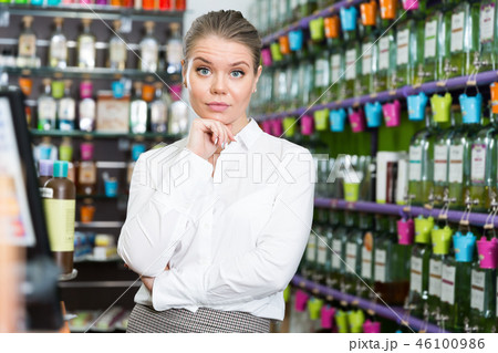 Girl customer thinking about buying new fragrance in store 46100986