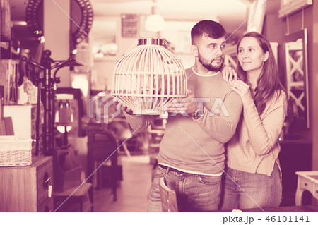 Couple looking for stylish hanging lamp Couple looking for stylish hanging lamp 46101141