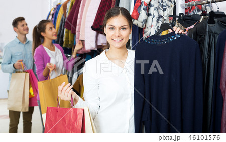 Female assistant serving happy customers Female assistant serving happy customers 46101576